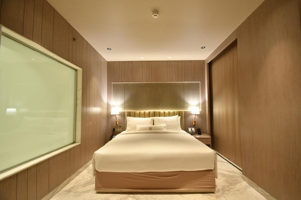 a bedroom with a large bed and a window at Vividus in Bengaluru a bedroom with a large bed and a window at Vividus in Bengaluru