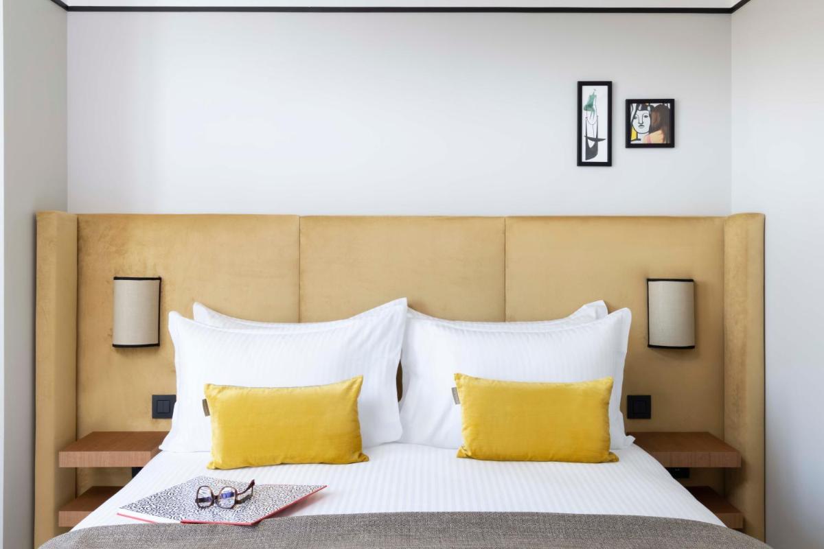 Un ou plusieurs lits dans un hébergement de l'établissement Hotel Le 37 Bis