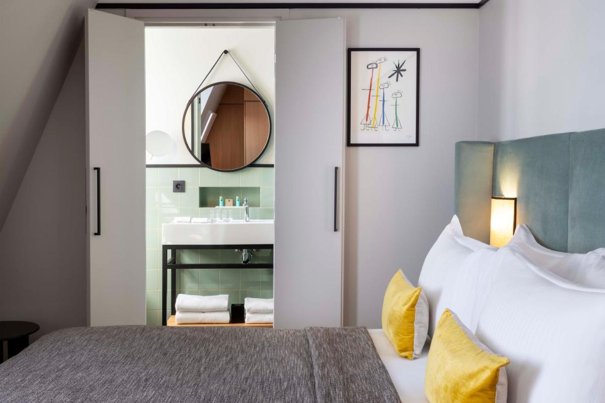 Un ou plusieurs lits dans un hébergement de l'établissement Hotel Le 37 Bis
