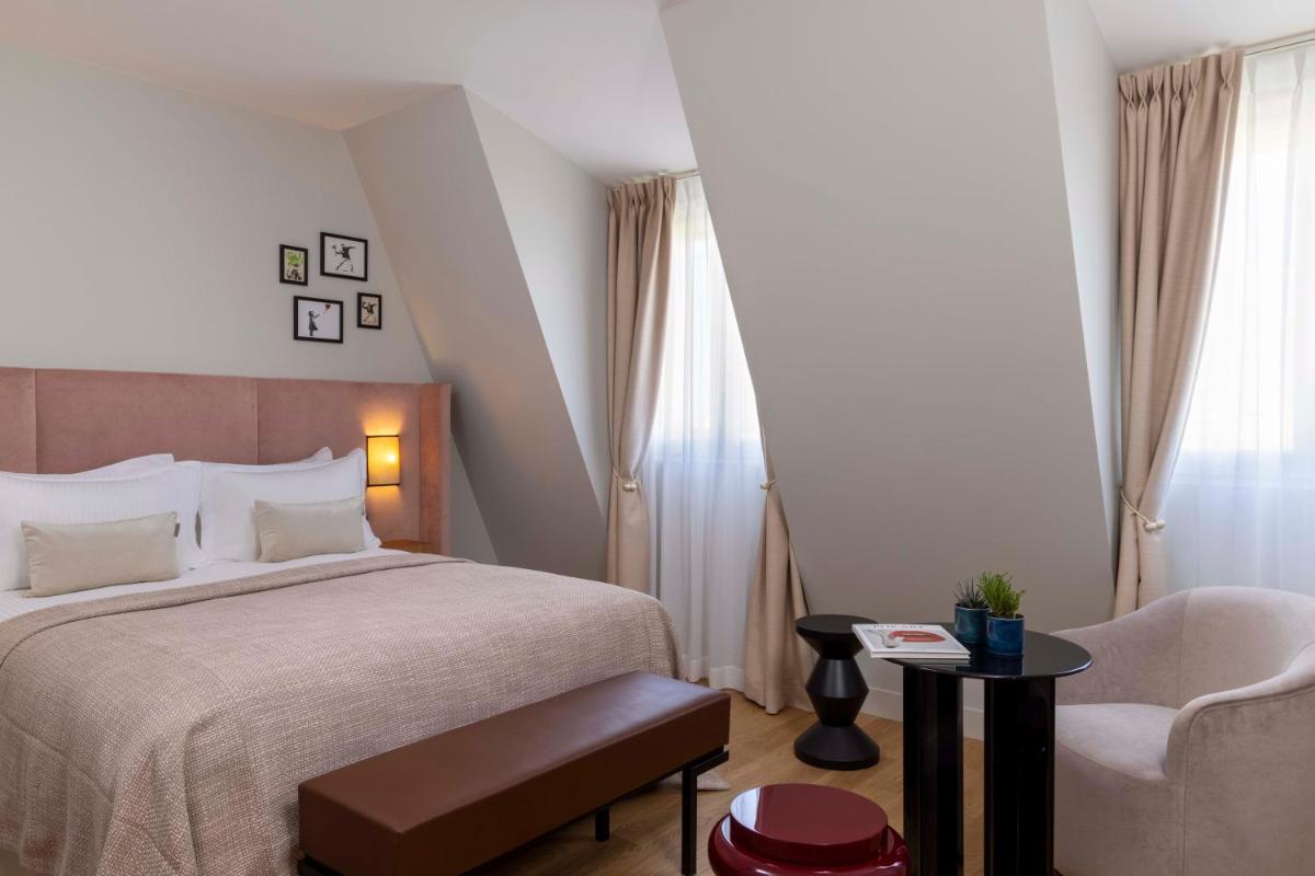 Un ou plusieurs lits dans un hébergement de l'établissement Hotel Le 37 Bis