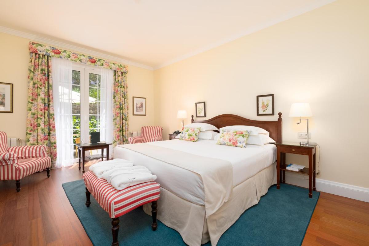 Uma cama ou camas num quarto em Casa Velha do Palheiro Relais & Chateaux