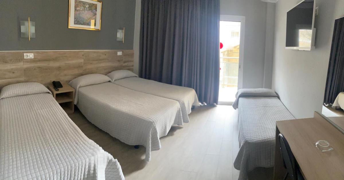Cama o camas de una habitación en Hotel Reymar