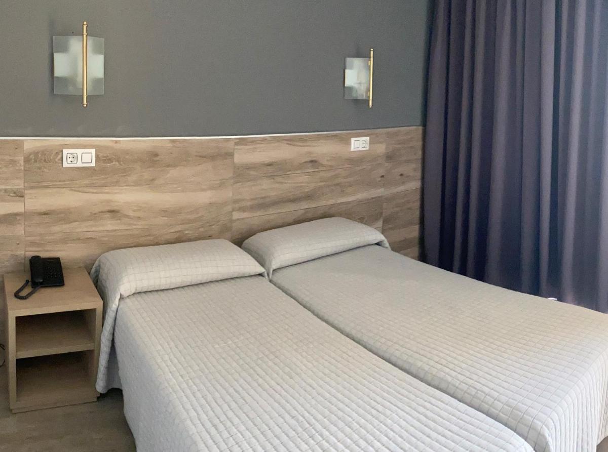 Cama o camas de una habitación en Hotel Reymar