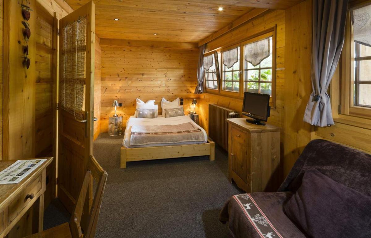 Un ou plusieurs lits dans un hébergement de l'établissement Chalet Hôtel & Spa Le Collet