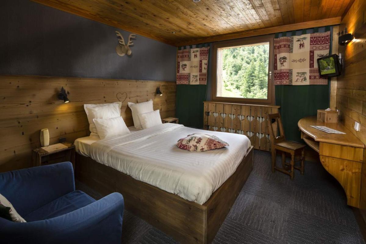 Un ou plusieurs lits dans un hébergement de l'établissement Chalet Hôtel & Spa Le Collet