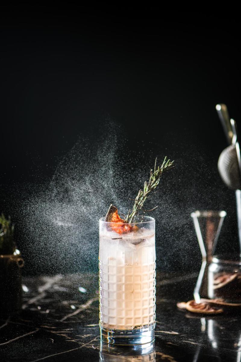 a drink on a table with a garnishment at Park Hyatt Hotel and Residences, Hyderabad in Hyderabad