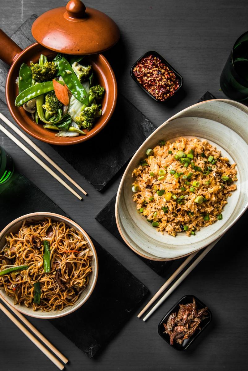 a table with plates of food and bowls of rice and vegetables at Park Hyatt Hotel and Residences, Hyderabad in Hyderabad