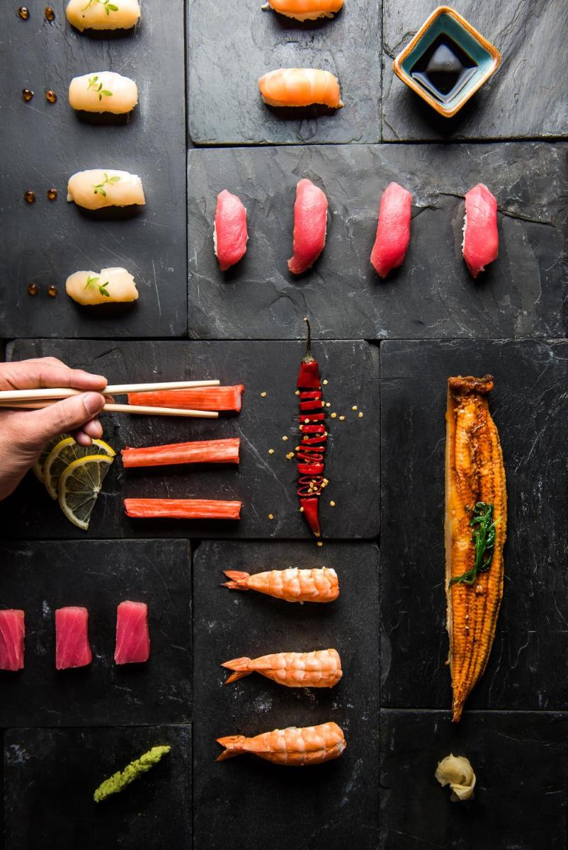 a table with vegetables and a person holding a knife at Park Hyatt Hotel and Residences, Hyderabad in Hyderabad