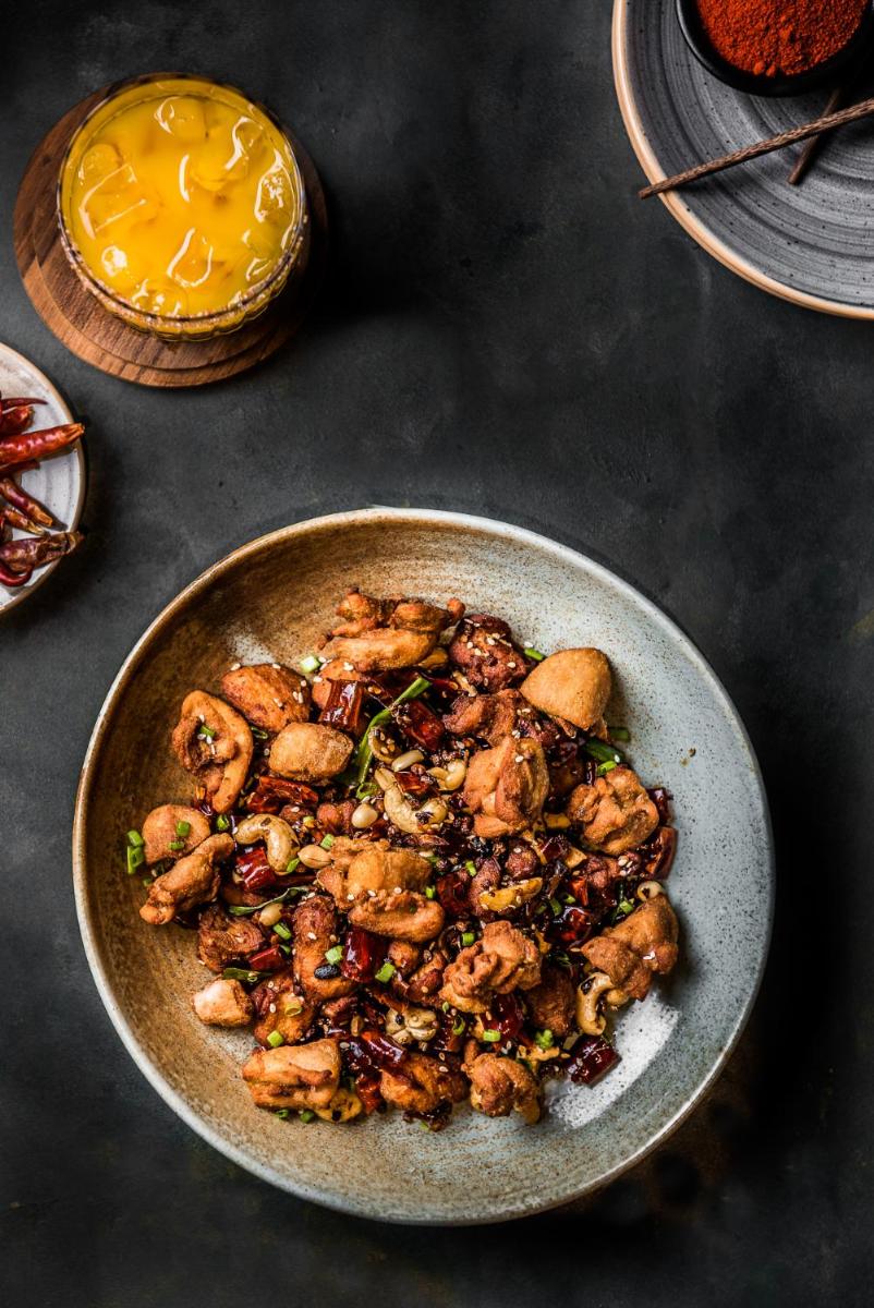a bowl of food with chicken and other foods at Park Hyatt Hotel and Residences, Hyderabad in Hyderabad