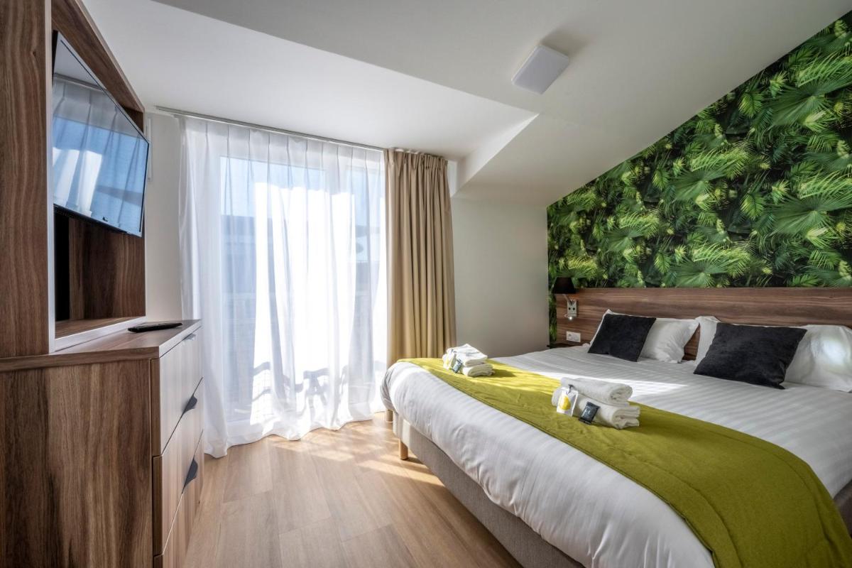 Un ou plusieurs lits dans un hébergement de l'établissement ATHOME RESIDENCE ET SPA