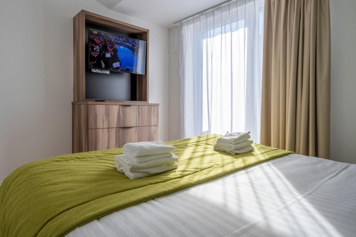 Un ou plusieurs lits dans un hébergement de l'établissement ATHOME RESIDENCE ET SPA