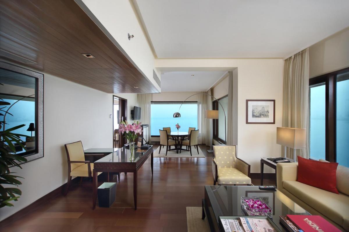 a living room with a couch and a table at The Oberoi Mumbai in Mumbai