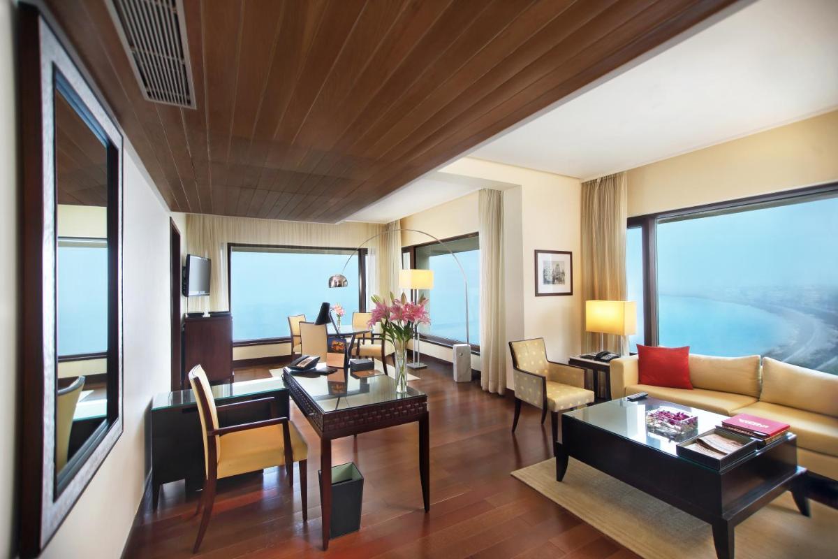 a living room with a couch and a table at The Oberoi Mumbai in Mumbai