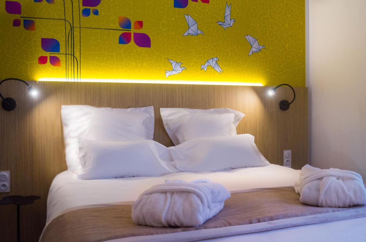 Un ou plusieurs lits dans un hébergement de l'établissement Kyriad Prestige Amiens Poulainville - Hotel and Spa