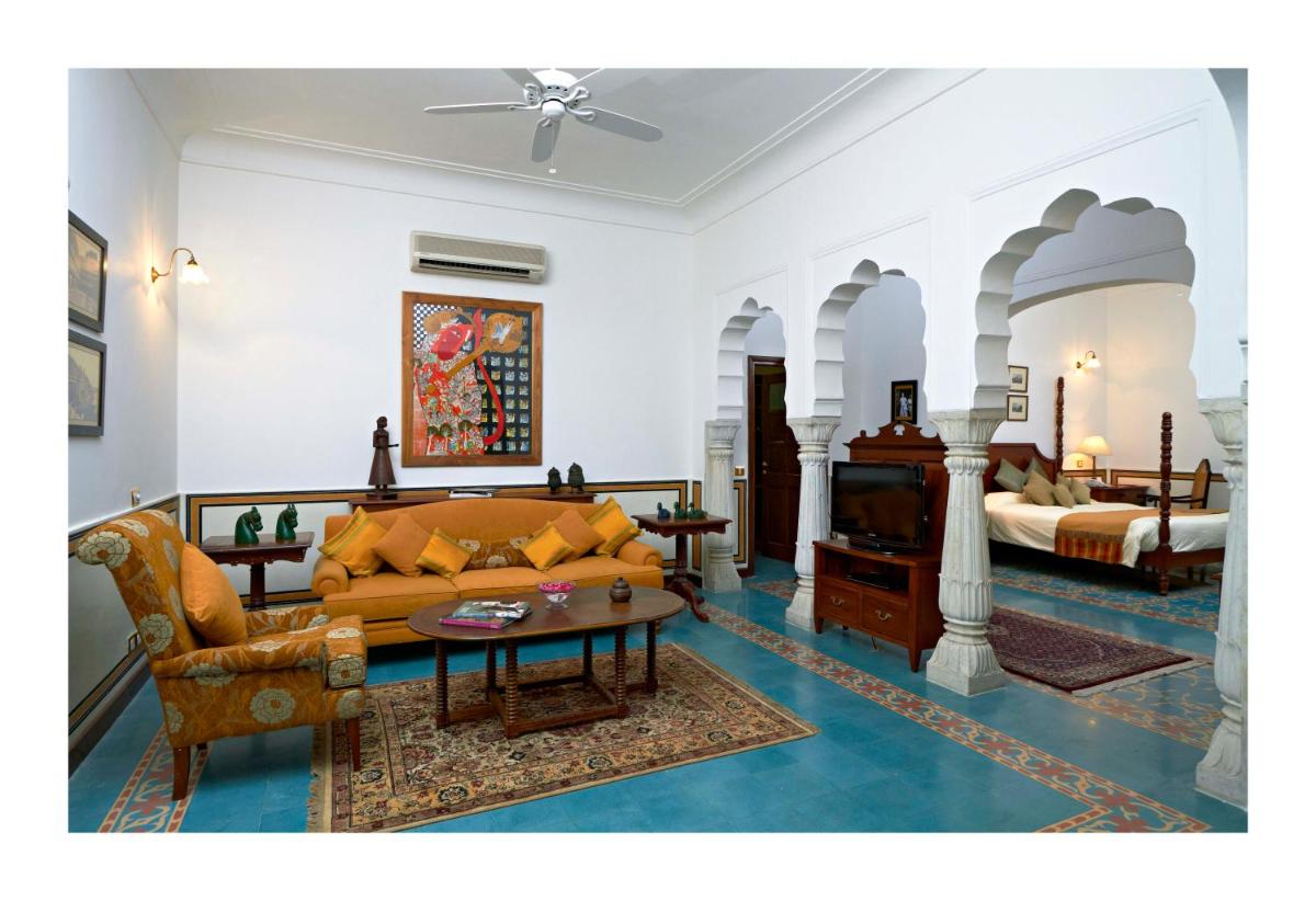 a living room with a couch and a table at Samode Haveli in Jaipur