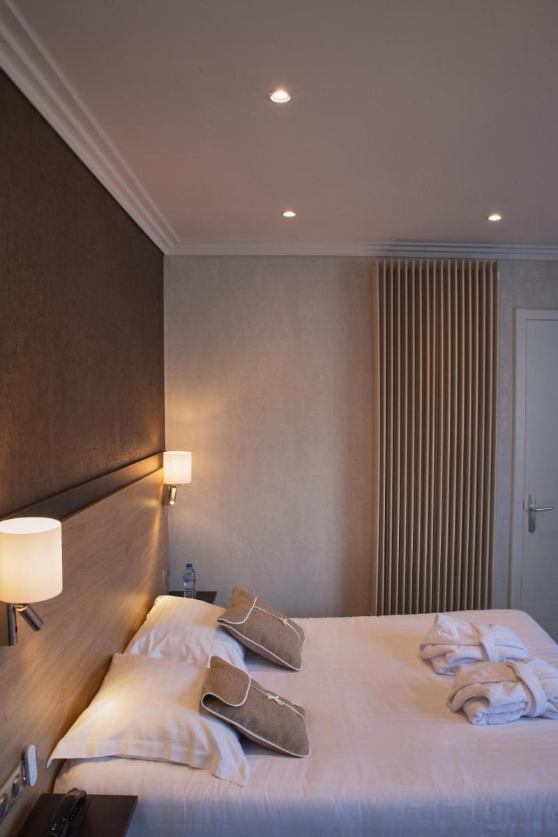Un ou plusieurs lits dans un hébergement de l'établissement Hôtel Beau Rivage