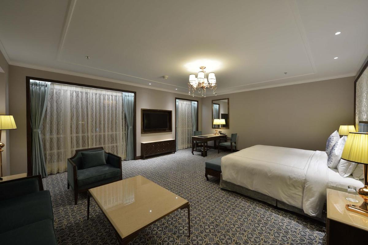a hotel room with a bed and a television at Taj Skyline Ahmedabad in Ahmedabad