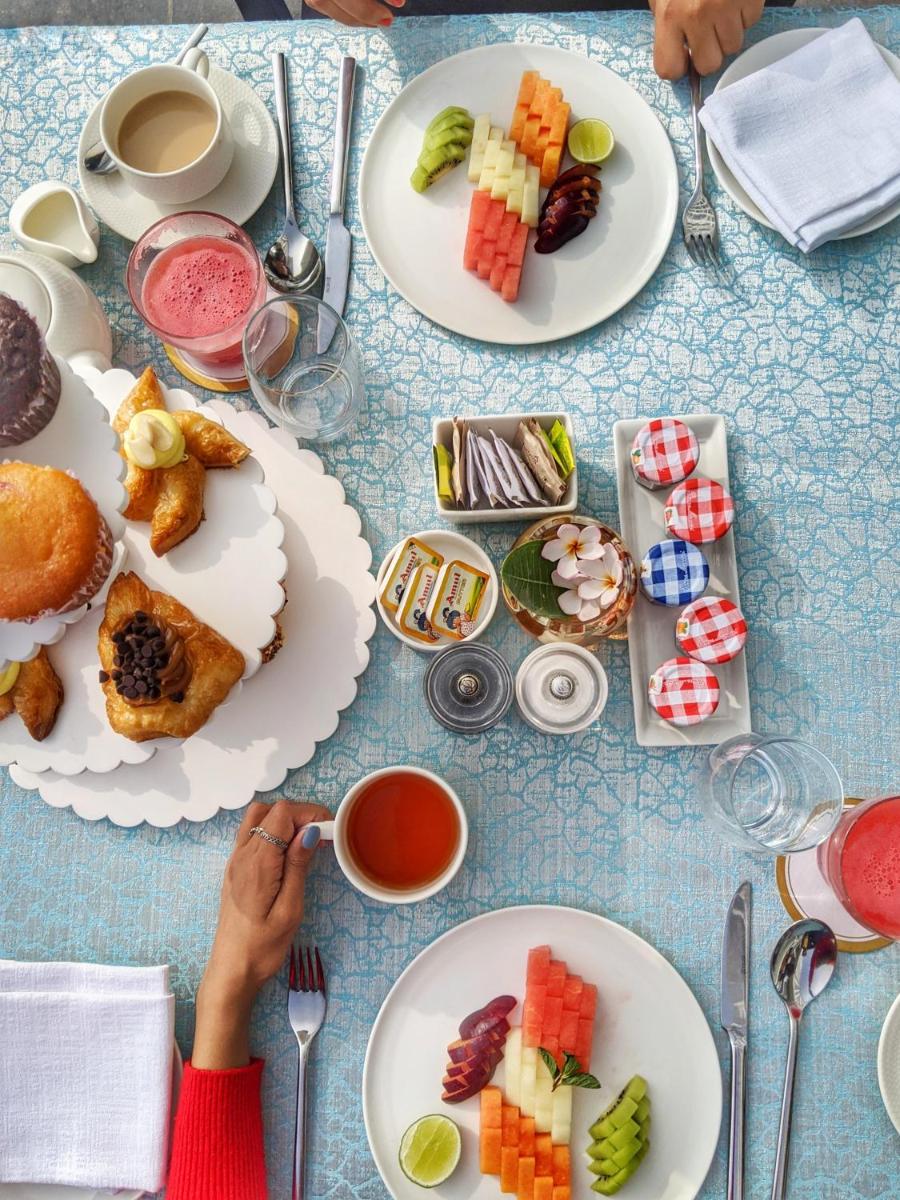 a table with plates of food on it at Taj Skyline Ahmedabad in Ahmedabad