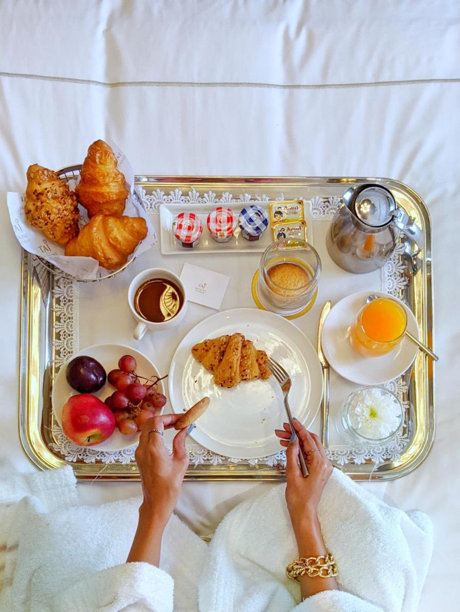 a tray of food with a tray of breakfast foods at Taj Skyline Ahmedabad in Ahmedabad