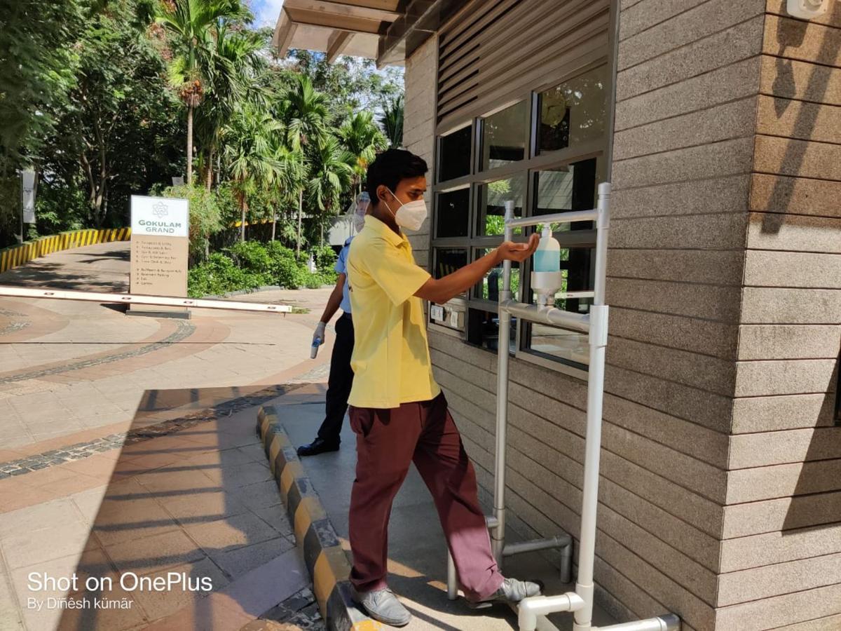 a man wearing a mask standing outside of a building at Gokulam Grand Hotel & Spa Bangalore in Bengaluru a man wearing a mask standing outside of a building at Gokulam Grand Hotel & Spa Bangalore in Bengaluru