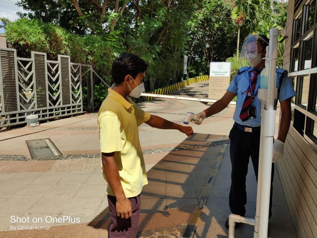 a man in a mask standing next to a man in a pole at Gokulam Grand Hotel & Spa Bangalore in Bengaluru a man in a mask standing next to a man in a pole at Gokulam Grand Hotel & Spa Bangalore in Bengaluru