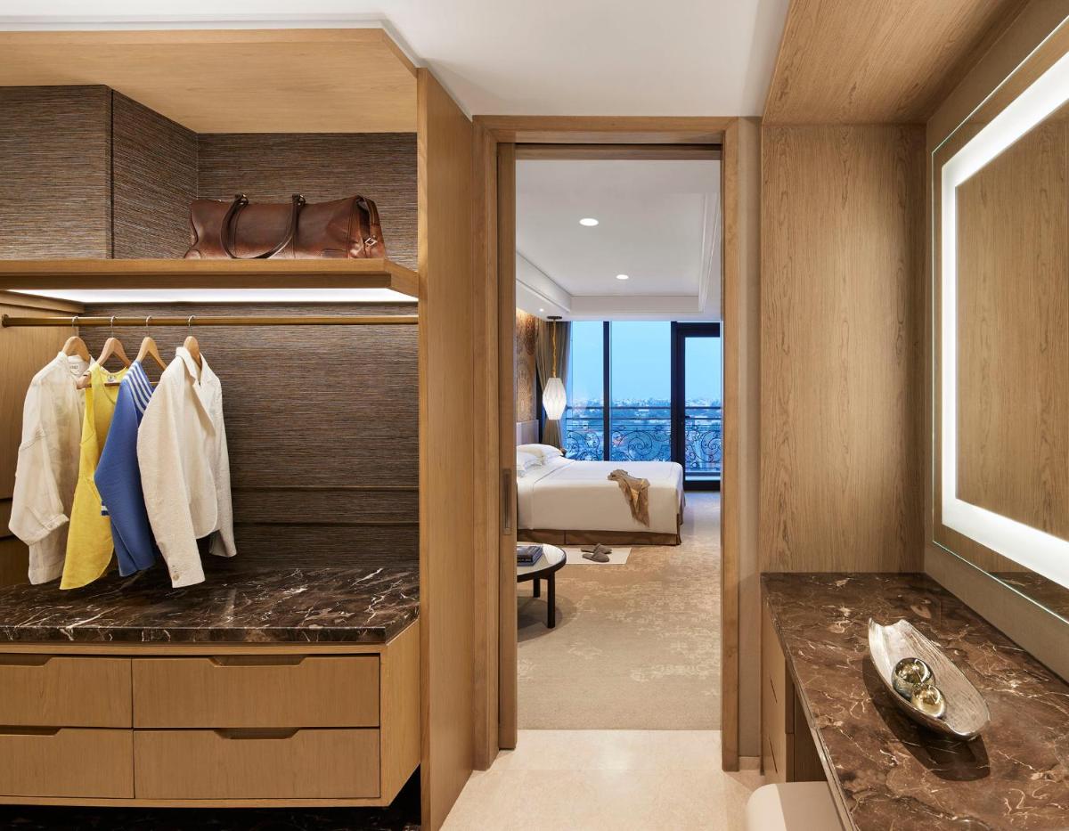 a master bedroom with a large closet with a bed at Taj Wellington Mews Chennai in Chennai