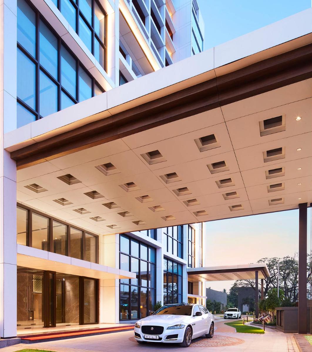 a white car parked in front of a building at Taj Wellington Mews Chennai in Chennai