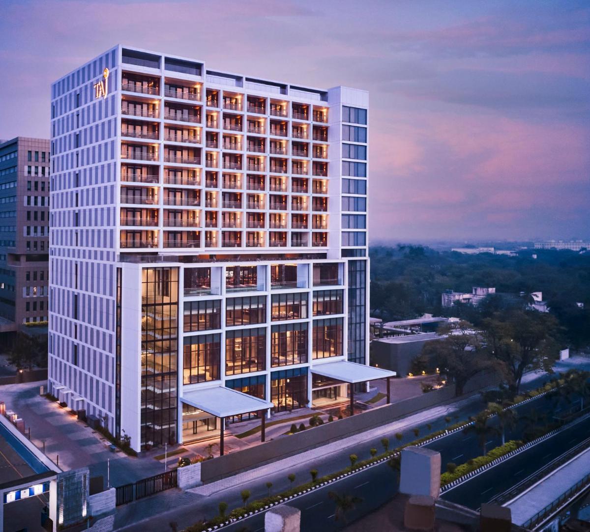 a rendering of a tall building with lights on at Taj Wellington Mews Chennai in Chennai