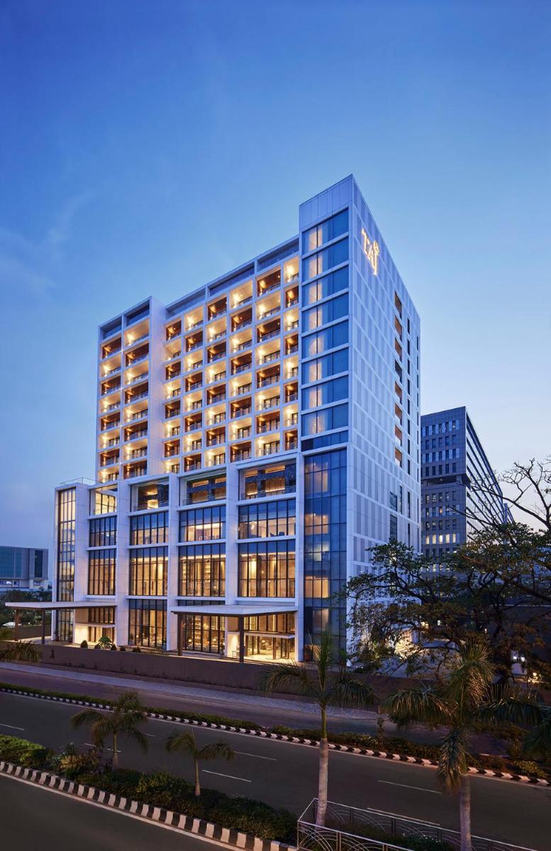 a tall building with lights on in a city at Taj Wellington Mews Chennai in Chennai