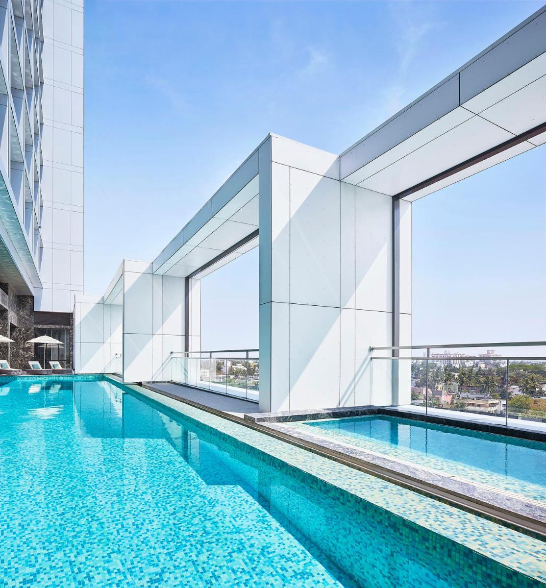 a swimming pool on the side of a building at Taj Wellington Mews Chennai in Chennai