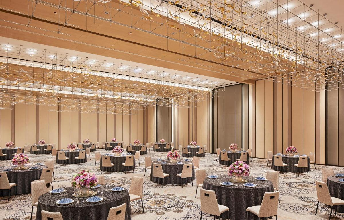 a large banquet hall with tables and chairs at Taj Wellington Mews Chennai in Chennai