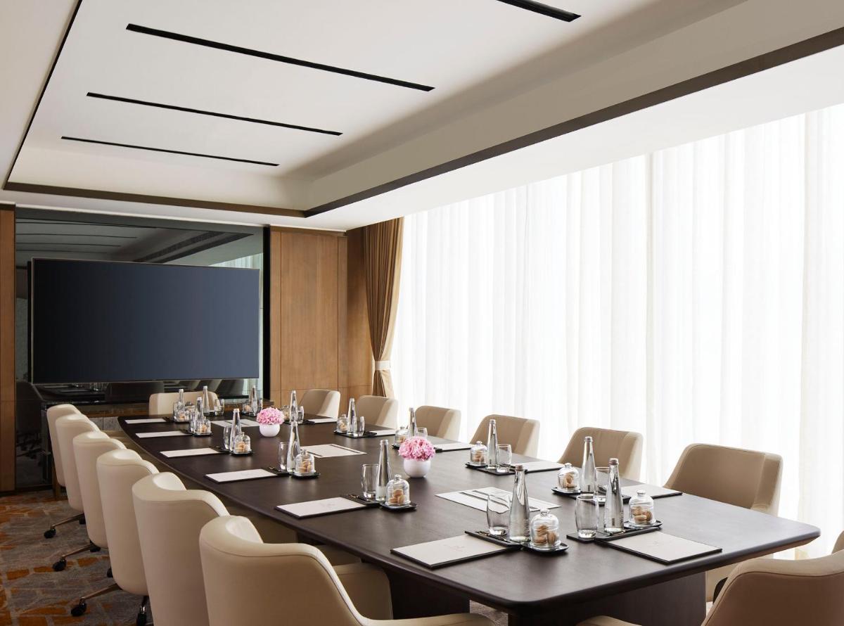 a conference room with a long table and chairs at Taj Wellington Mews Chennai in Chennai +25 photos