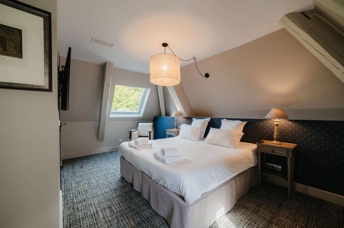 Un ou plusieurs lits dans un hébergement de l'établissement Hôtel La Robéyère - BW Signature Collection