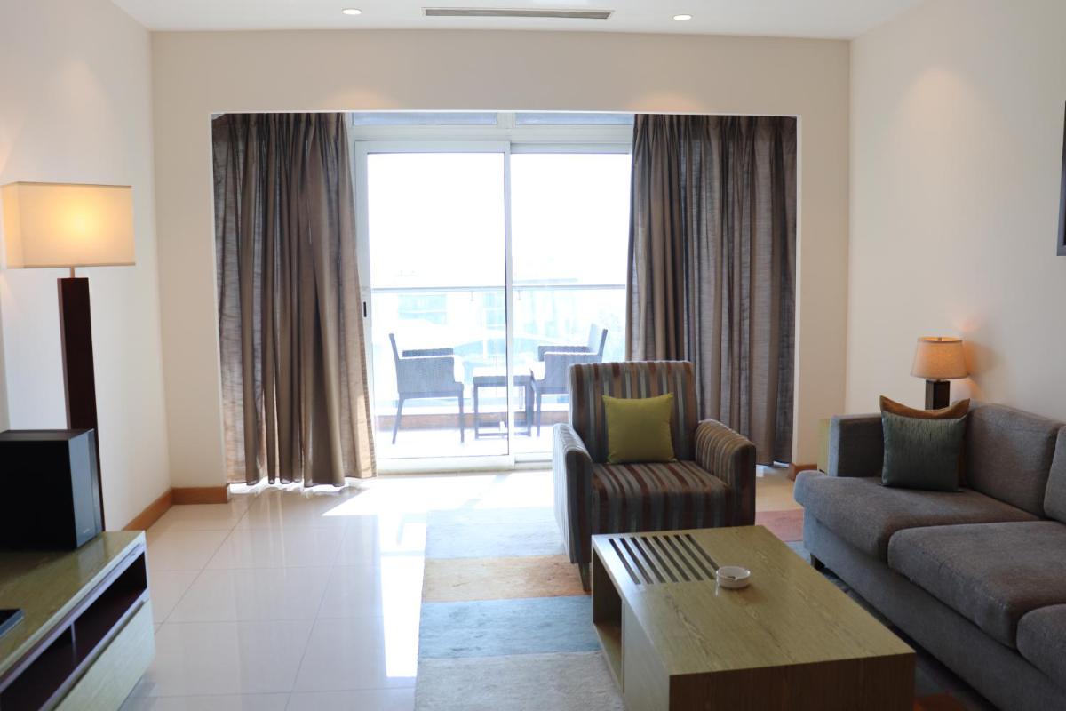 a living room with a couch and a table at Oakwood Residence Kapil Hyderabad in Hyderabad