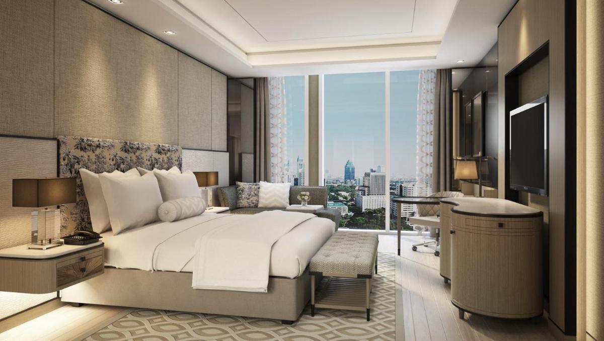 a bedroom with a large bed and a large window at The Leela Bhartiya City Bengaluru in Bengaluru a bedroom with a large bed and a large window at The Leela Bhartiya City Bengaluru in Bengaluru