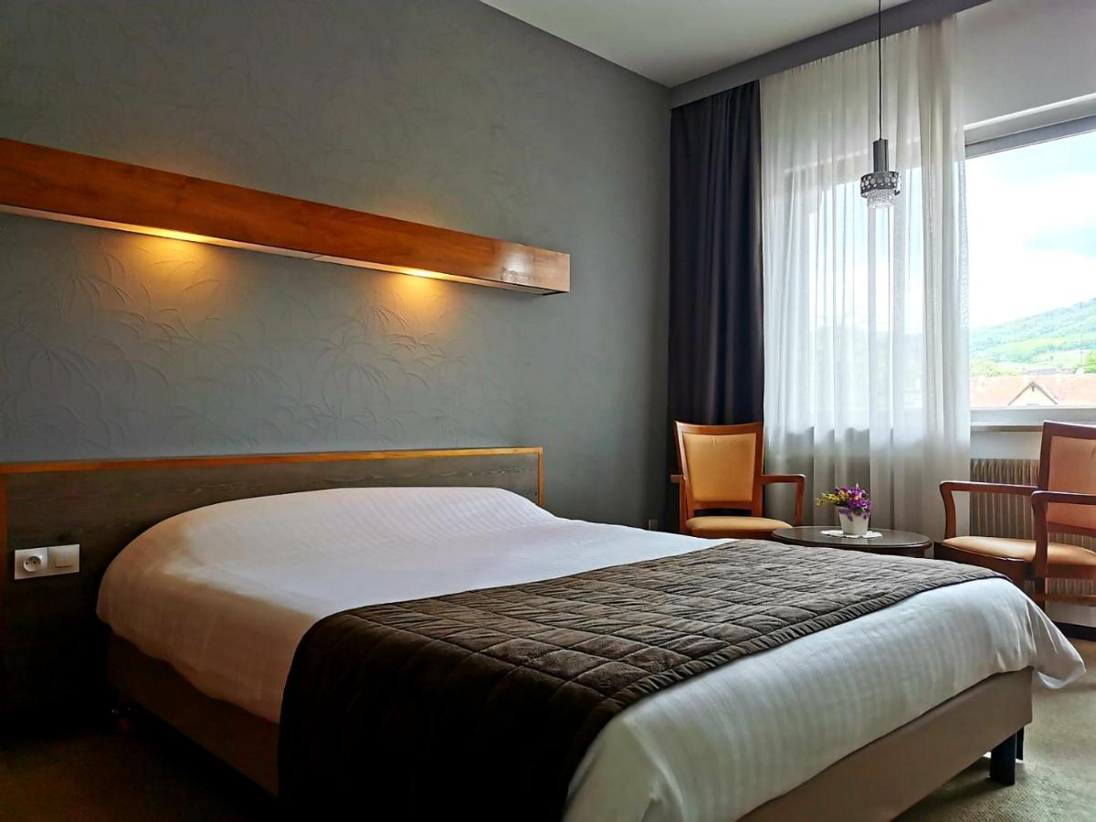 Un ou plusieurs lits dans un hébergement de l'établissement Hotel Munsch Restaurant & Wellness, Colmar Nord - Haut-Koenigsbourg