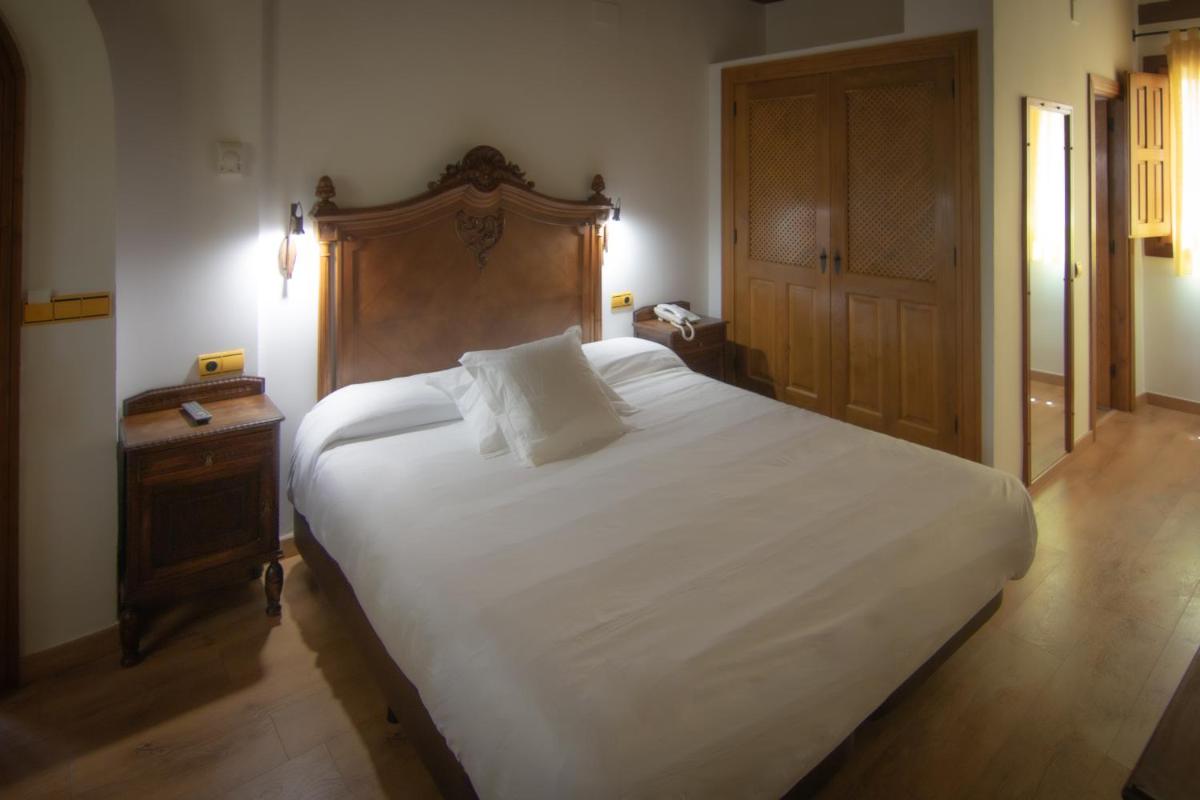 Cama o camas de una habitación en Hospedium Hotel Rural Abadía de Yuste