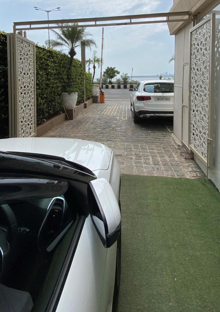 a white car parked in front of a house at InterContinental Marine Drive Mumbai by IHG in Mumbai