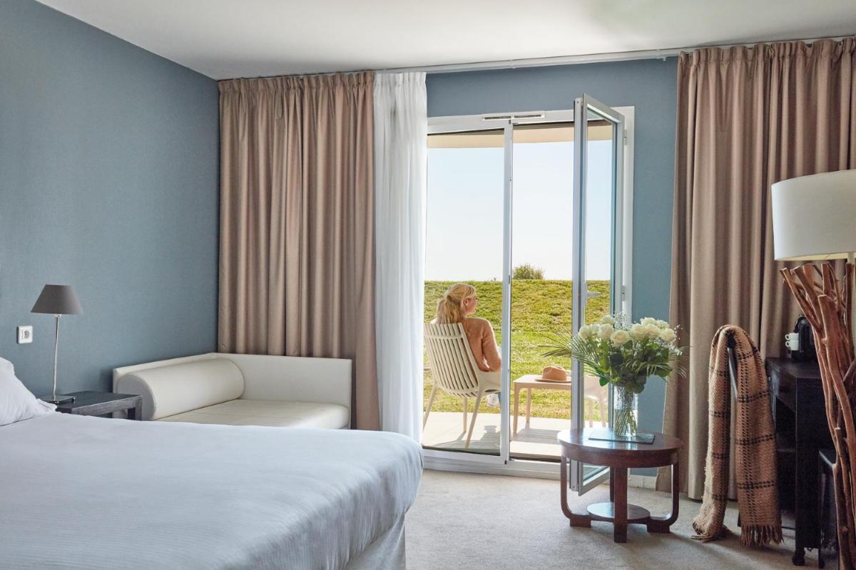 Un ou plusieurs lits dans un hébergement de l'établissement Hôtel Atalante - Relais Thalasso & Spa