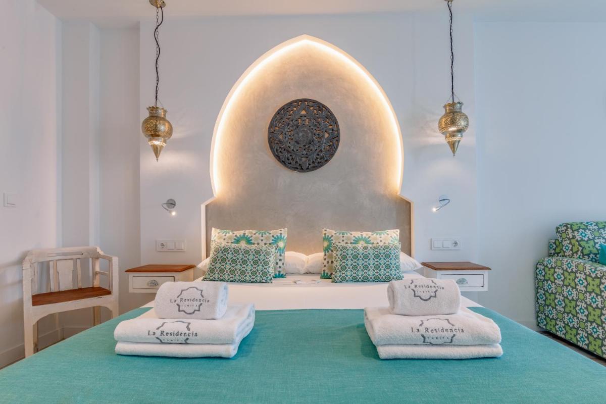 Cama o camas de una habitación en La Residencia Puerto Hotel & Spa