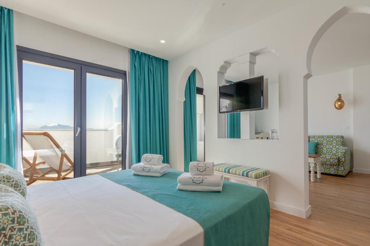Cama o camas de una habitación en La Residencia Puerto Hotel & Spa