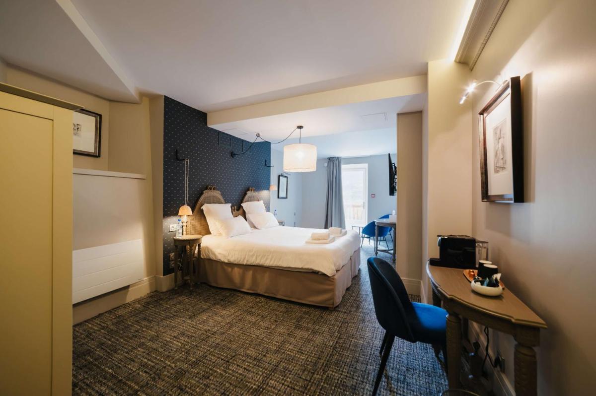 Un ou plusieurs lits dans un hébergement de l'établissement Hôtel La Robéyère - BW Signature Collection