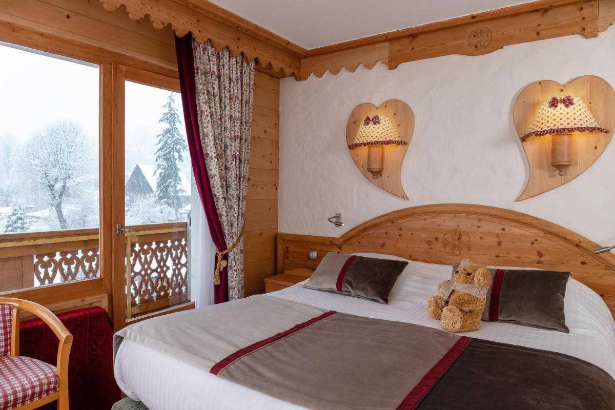 Un ou plusieurs lits dans un hébergement de l'établissement Chalet-Hôtel Neige et Roc, The Originals Relais