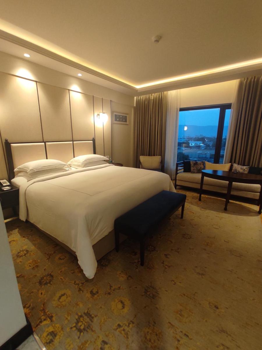 a large hotel room with a large bed and a window at Taj Tirupati in Tirupati