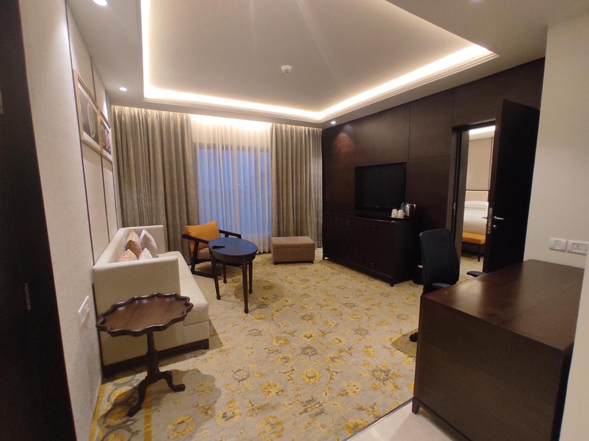 a large hotel room with a living room at Taj Tirupati in Tirupati