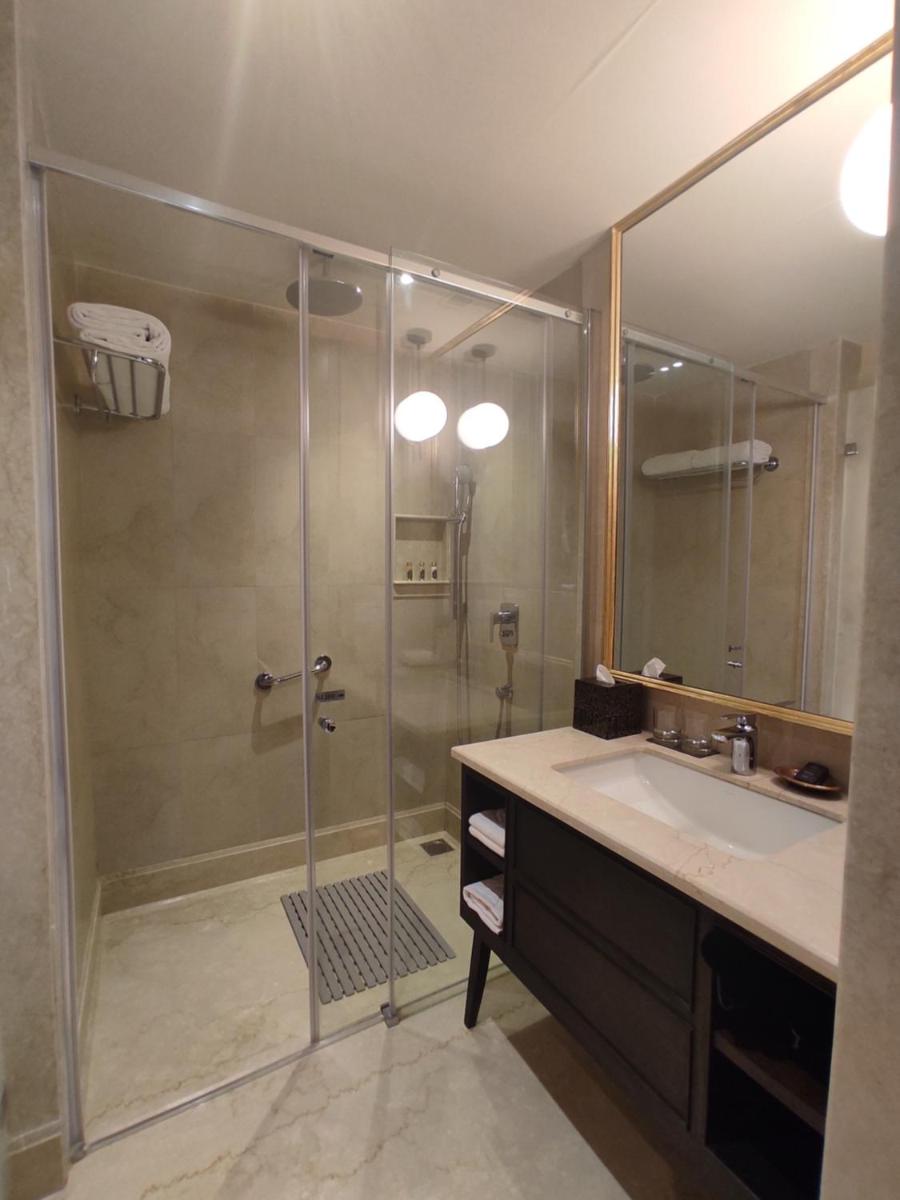 a bathroom with a shower and a sink at Taj Tirupati in Tirupati