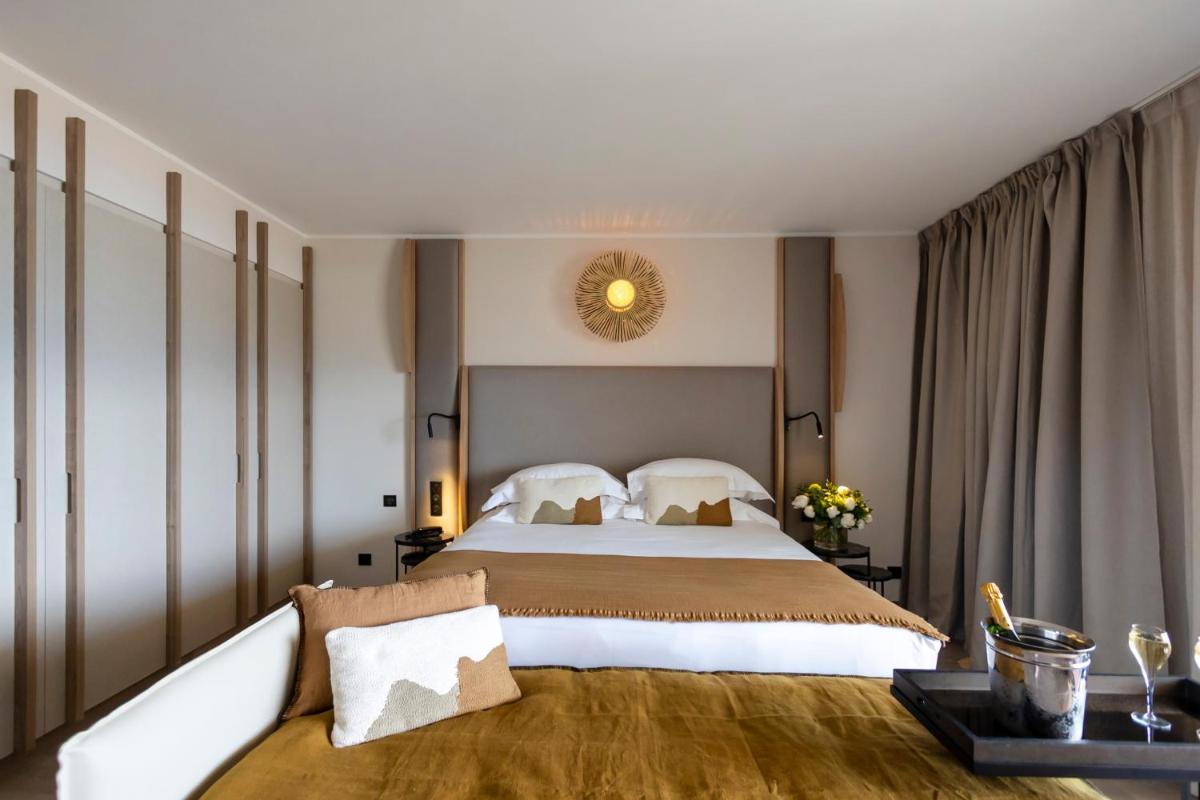 Un ou plusieurs lits dans un hébergement de l'établissement Hotel L'Acquale