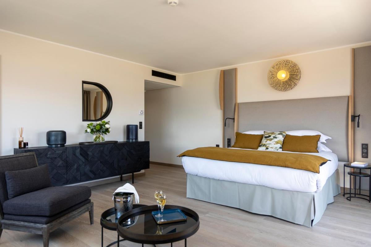 Un ou plusieurs lits dans un hébergement de l'établissement Hotel L'Acquale