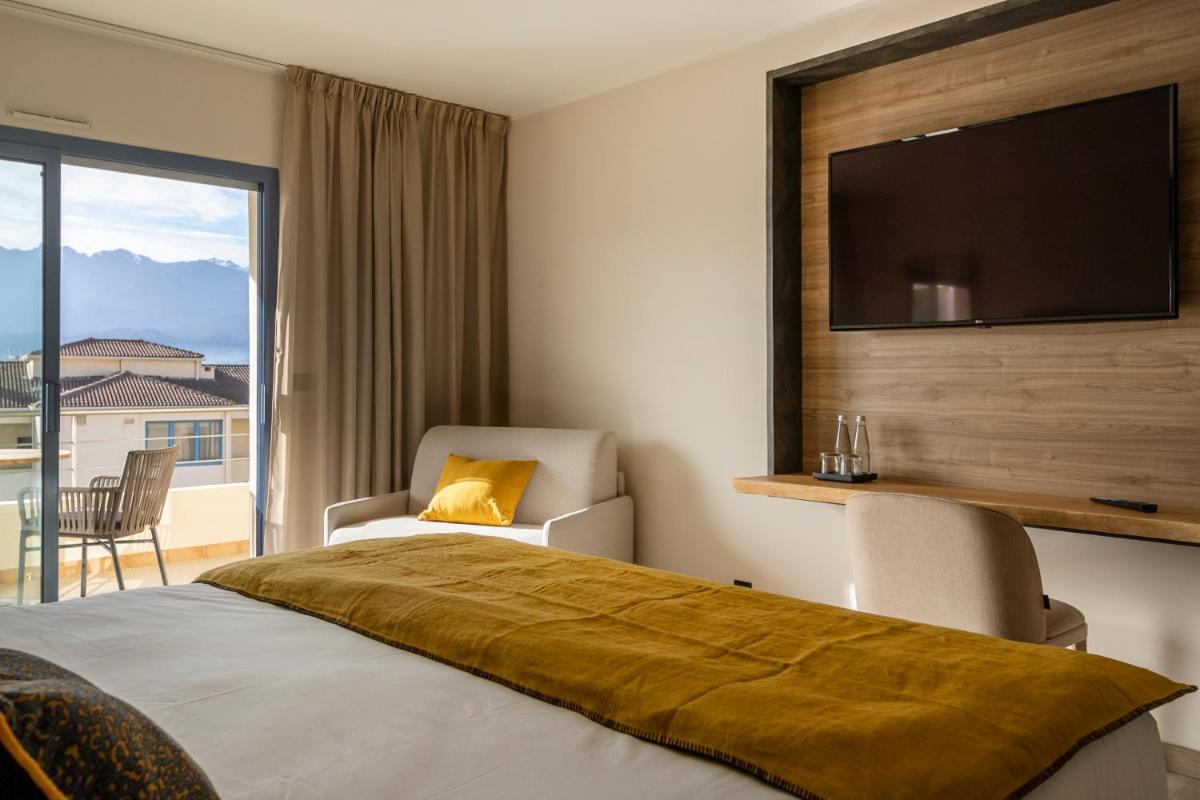 Un ou plusieurs lits dans un hébergement de l'établissement Hotel L'Acquale