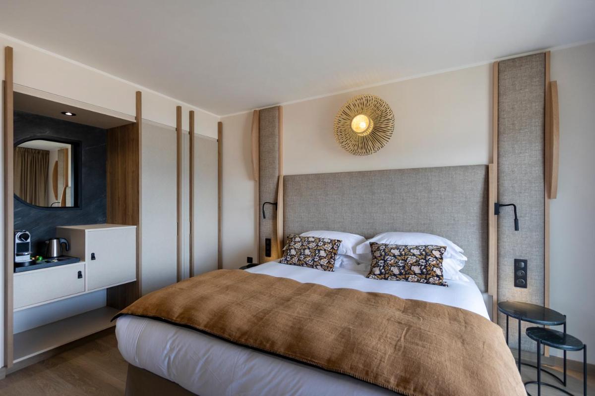 Un ou plusieurs lits dans un hébergement de l'établissement Hotel L'Acquale